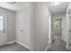 Hallway with wood floors, laundry hookups, and a view into the carpeted bedroom at 2222 Oak Ridge Blvd, Durham, NC 27707
