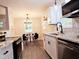 Open kitchen featuring stainless steel appliances, granite countertops, and modern lighting at 2222 Oak Ridge Blvd, Durham, NC 27707