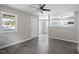 Bright living room with ceiling fan connects to entry door and updated kitchen at 2222 Oak Ridge Blvd, Durham, NC 27707