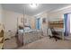 Bright bedroom featuring a four-poster bed and a charming writing desk, perfect for relaxation and creativity at 2503 Macdougall Dr, Burlington, NC 27217