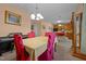 A dining room with views to the kitchen and decorated dining chairs, a dining table, and light fixture at 2503 Macdougall Dr, Burlington, NC 27217