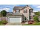 Charming two-story home with red shutters, well-maintained lawn, and attached two-car garage at 2503 Macdougall Dr, Burlington, NC 27217