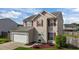 Inviting two-story home with red shutters, attached garage, and professionally landscaped front yard at 2503 Macdougall Dr, Burlington, NC 27217