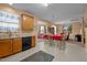A kitchen open to a dining and living room area with wood cabinets and neutral colors at 2503 Macdougall Dr, Burlington, NC 27217