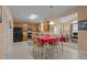 An open eat-in kitchen with wood cabinets, black appliances, and a breakfast table at 2503 Macdougall Dr, Burlington, NC 27217