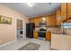 A kitchen with wood cabinets and stainless steel and black appliances at 2503 Macdougall Dr, Burlington, NC 27217