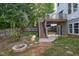 The backyard features a deck with a staircase, a concrete patio and a lovely fire pit at 2612 Alder Ridge Ln, Raleigh, NC 27603