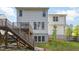 Backyard view of a home's rear exterior with a deck, stairs, and partially finished basement at 2612 Alder Ridge Ln, Raleigh, NC 27603