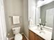 Cozy half bathroom with hardwood floors, vanity, and toilet at 2612 Alder Ridge Ln, Raleigh, NC 27603