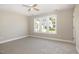 Bedroom with neutral walls and carpet plus ceiling fan and abundant natural light at 2612 Alder Ridge Ln, Raleigh, NC 27603