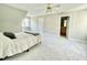 Neutral bedroom features a ceiling fan, natural light and ensuite bathroom at 2612 Alder Ridge Ln, Raleigh, NC 27603