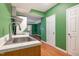 Kitchenette with wood cabinets, stainless steel sink, and view into the other room at 2612 Alder Ridge Ln, Raleigh, NC 27603