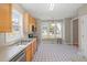Bright kitchen features stainless steel appliances, light wood cabinets, and a breakfast nook with large windows at 2612 Alder Ridge Ln, Raleigh, NC 27603