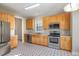 Well-lit kitchen features stainless steel appliances, light wood cabinets, and patterned floor at 2612 Alder Ridge Ln, Raleigh, NC 27603