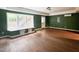 Living area with hardwood-style floors, green walls, and a window seat at 2612 Alder Ridge Ln, Raleigh, NC 27603