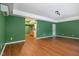 Living area with hardwood-style floors and green painted walls at 2612 Alder Ridge Ln, Raleigh, NC 27603
