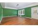 Living area with green walls, hardwood-style floors, and a window seat at 2612 Alder Ridge Ln, Raleigh, NC 27603
