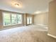 Expansive living room with neutral walls and large windows, filled with natural light at 2612 Alder Ridge Ln, Raleigh, NC 27603