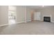Spacious living room features plush carpeting, a fireplace, and an open doorway to the kitchen at 2612 Alder Ridge Ln, Raleigh, NC 27603