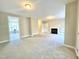 Spacious living room features a fireplace and neutral carpet and paint at 2612 Alder Ridge Ln, Raleigh, NC 27603