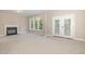 Bright living room with fireplace, carpet, and French doors to the outside at 2612 Alder Ridge Ln, Raleigh, NC 27603