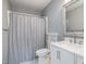 Charming bathroom featuring a white vanity, shower and neutral-toned walls, and a window at 2708 Tryon Pines Dr, Raleigh, NC 27603