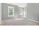 A spacious bedroom with natural light streams in from large windows and neutral carpet at 2708 Tryon Pines Dr, Raleigh, NC 27603