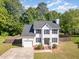 Beautiful home featuring a well-kept lawn, attached garage, and inviting front entrance with manicured landscaping at 2708 Tryon Pines Dr, Raleigh, NC 27603