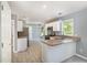 Bright kitchen with white cabinets, modern appliances, and wood look floors at 2708 Tryon Pines Dr, Raleigh, NC 27603