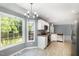 Kitchen features white cabinetry, stainless appliances, and a breakfast nook at 2708 Tryon Pines Dr, Raleigh, NC 27603