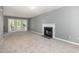 Living room with fireplace and French doors leading to the outdoor space at 2708 Tryon Pines Dr, Raleigh, NC 27603