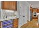 Stylish bar area with wine fridge, marble countertops, and custom cabinetry at 2723 Cameron Pond Dr, Cary, NC 27519