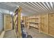 Unfinished basement space with brick floor and shelving, ready for customization at 2723 Cameron Pond Dr, Cary, NC 27519