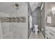 Modern bathroom featuring a tiled shower with a built-in seat and decorative mosaic accents and decorative artwork at 2723 Cameron Pond Dr, Cary, NC 27519