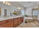 Bathroom featuring double sinks, a large mirror and a separate shower and tub at 2723 Cameron Pond Dr, Cary, NC 27519