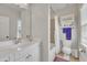 Bathroom featuring a white vanity, tiled shower, and storage cabinet for a clean and functional space at 2723 Cameron Pond Dr, Cary, NC 27519