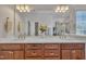 Bathroom featuring double sinks, a large mirror and a separate shower at 2723 Cameron Pond Dr, Cary, NC 27519