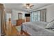 Bedroom featuring wood floors, a large bed, and neutral decor with plenty of natural light at 2723 Cameron Pond Dr, Cary, NC 27519