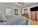 Bedroom featuring wood floors, a large bed, and neutral decor with plenty of natural light at 2723 Cameron Pond Dr, Cary, NC 27519