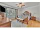 Spacious bedroom with hardwood floors, ceiling fan, and large window with curtains at 2723 Cameron Pond Dr, Cary, NC 27519