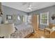 Light filled bedroom with hardwood floors, detailed mirror accents, window views, and a neutral color palette at 2723 Cameron Pond Dr, Cary, NC 27519