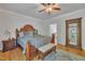 Bedroom featuring wood floors, a large bed, and neutral decor with plenty of natural light at 2723 Cameron Pond Dr, Cary, NC 27519