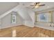 Spacious bonus room features a window bench, vaulted ceiling, natural light and hardwood floors for versatile use at 2723 Cameron Pond Dr, Cary, NC 27519