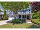 Charming blue house with a two-car garage, a front porch and beautiful landscaping at 2723 Cameron Pond Dr, Cary, NC 27519