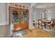 Elegant foyer featuring hardwood floors, a dining room view, and a beautiful wooden double-door entrance at 2723 Cameron Pond Dr, Cary, NC 27519