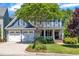 Charming blue two-story home with a covered porch, well-manicured lawn, and a two-car garage at 2723 Cameron Pond Dr, Cary, NC 27519