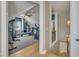 Bright upstairs gym features blue walls, carpeted floor, and many storage shelves at 2723 Cameron Pond Dr, Cary, NC 27519