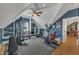 Spacious upper-level gym with workout equipment, blue walls, and ceiling fan at 2723 Cameron Pond Dr, Cary, NC 27519