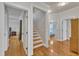 Inviting foyer with wood floors, staircase, and doorways leading to other rooms at 2723 Cameron Pond Dr, Cary, NC 27519