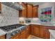 Gourmet kitchen boasts a professional Thor gas range, stylish backsplash, and custom cabinets at 2723 Cameron Pond Dr, Cary, NC 27519